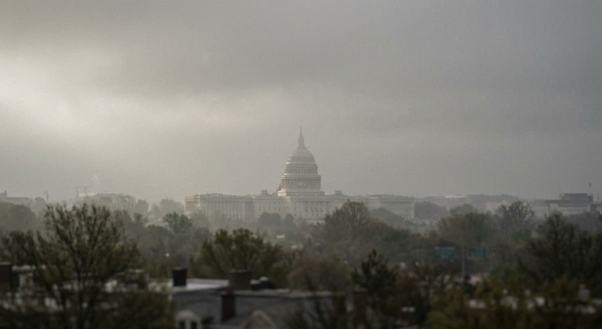the U.S. Capitol dome at a distance through haze, no people, muted tones