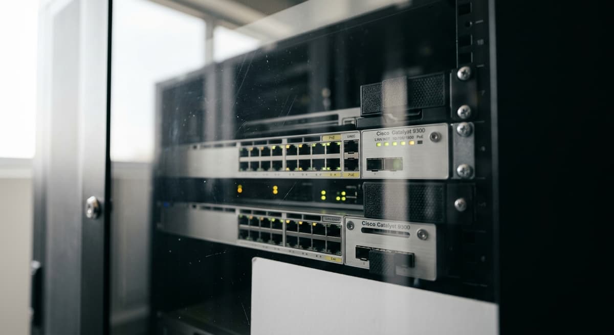 Kansas server rack with blinking LED lights behind a locked glass panel in a clean data center
