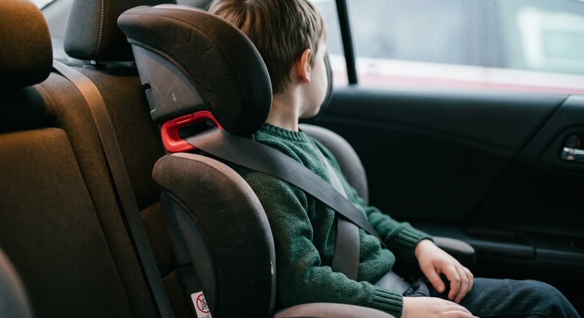 a high-back booster seat with the seatbelt routed through the belt guide