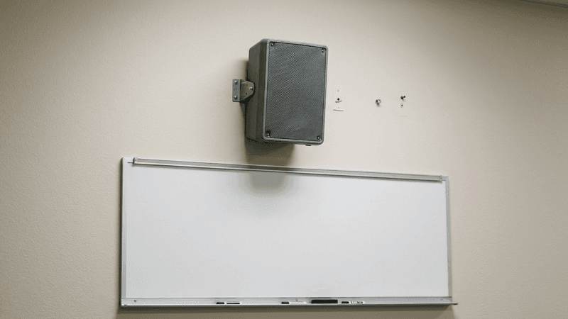 Kentucky school pa system speaker mounted on a classroom wall above the whiteboard