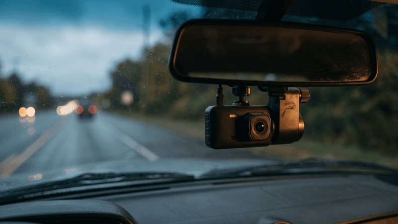 Texas dashcam mounted behind a rearview mirror inside a vehicle, road ahead visible th
