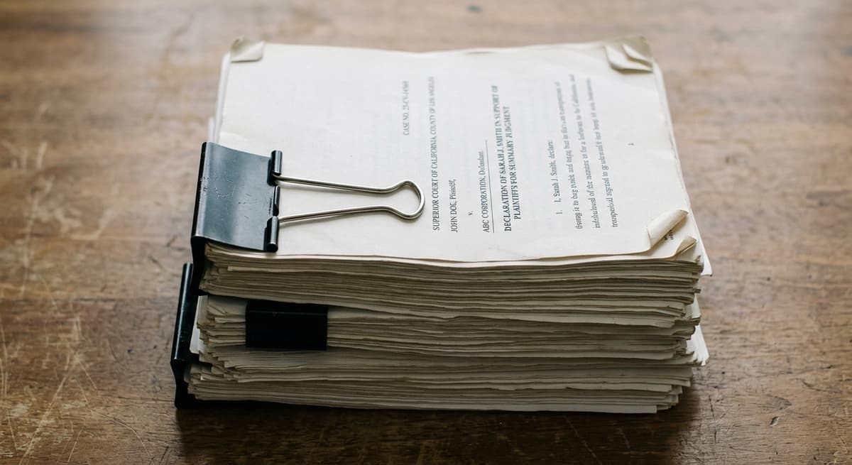 United States stack of court documents held together with a binder clip